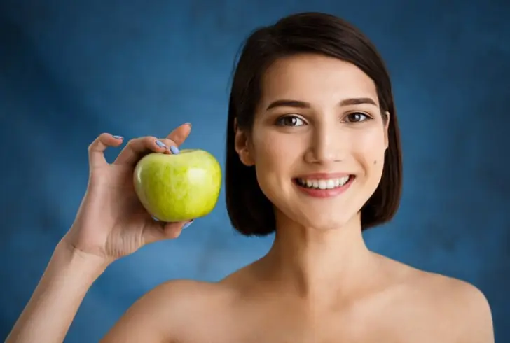 Does eating apples clean your teeth? Apples contain fiber that acts as a natural scrub.
