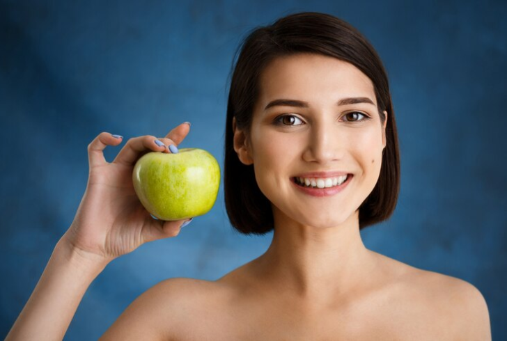 Does eating apples clean your teeth? Apples contain fiber that acts as a natural scrub.