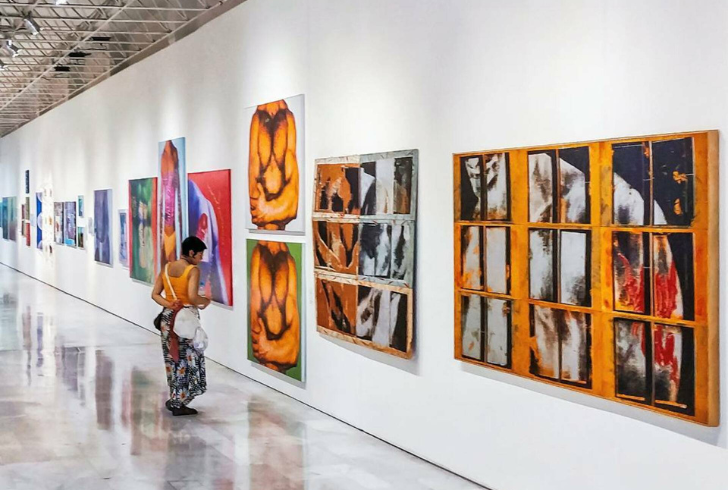 Woman walking peacefully through art gallery