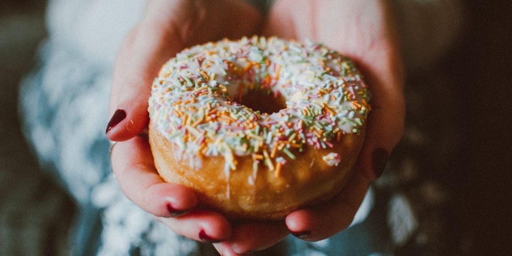 Delicious chocolate-frosted donut with colorful sprinkles